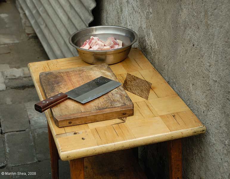 table with freshly cut meat in a bowl