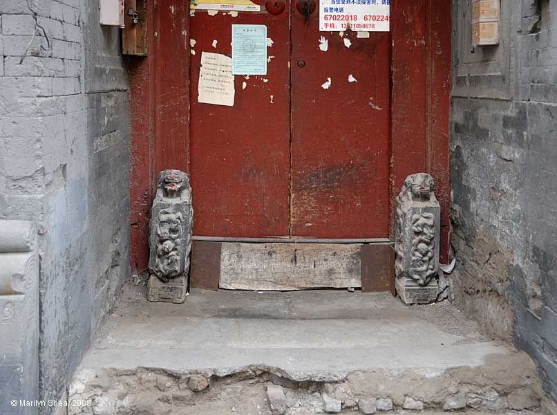 door guardians flant a hutong door