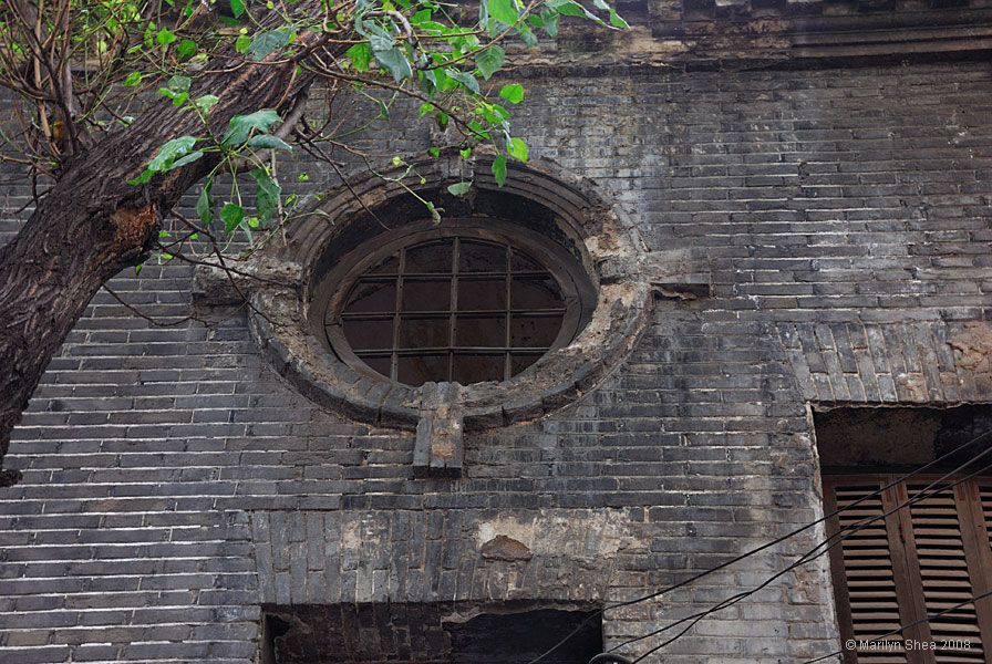 old round window in brick building