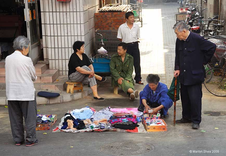 group sitting on stairs with sundries laid out on a blanket