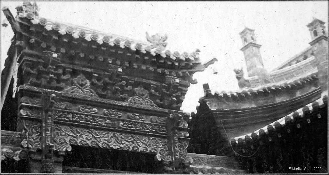 Elaborate wood carvings on traditional entryway.