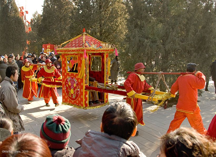 Four men carry a Qing Dynasty Sedan Chair