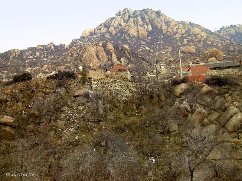 Stone and red brick homes shown from down the mountain