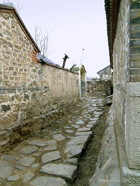 Alley with stone walls and stone flagstones