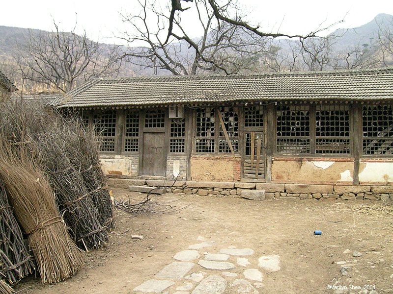 Old house with broken window and sagging roof line