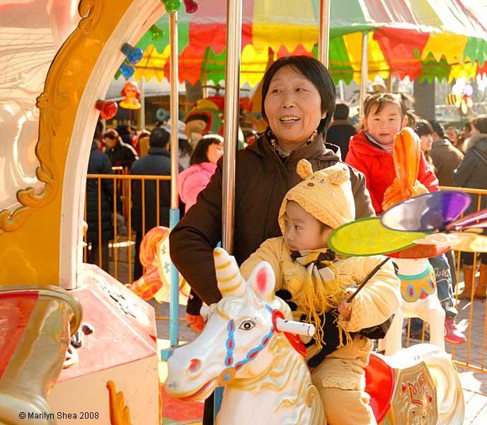 mother with child on merry-go-round