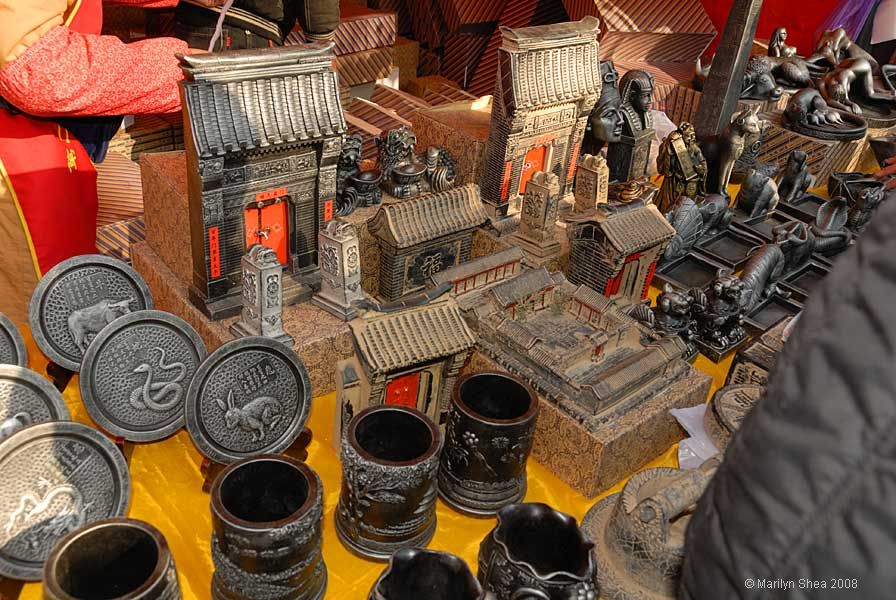 metal statues of temple gates and plates with Chinese animals symbols