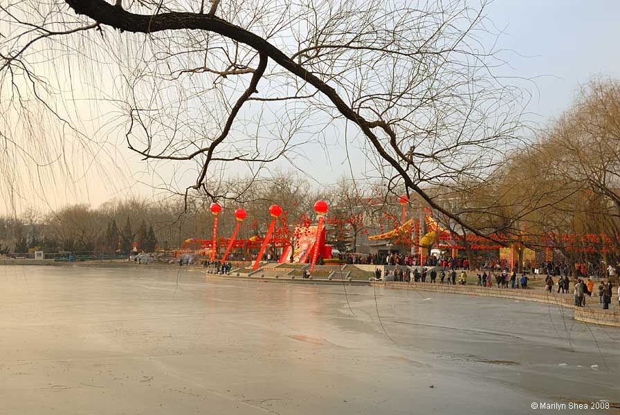 Red decorations seen across the frozen lake